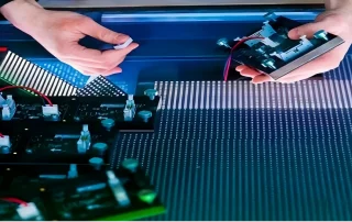 Technician troubleshooting and maintaining kinetic LED display panels