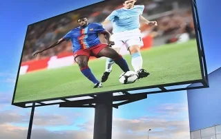 Outdoor LED billboard showing sports video, guide to brightness & sunlight readability
