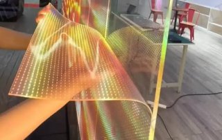 Transparent LED display installed behind glass, showcasing brightness, daylight visibility and heat performance